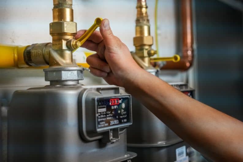 person adjusting a gas meter to reduce gas usage 2023 11 27 05 23 30 utc